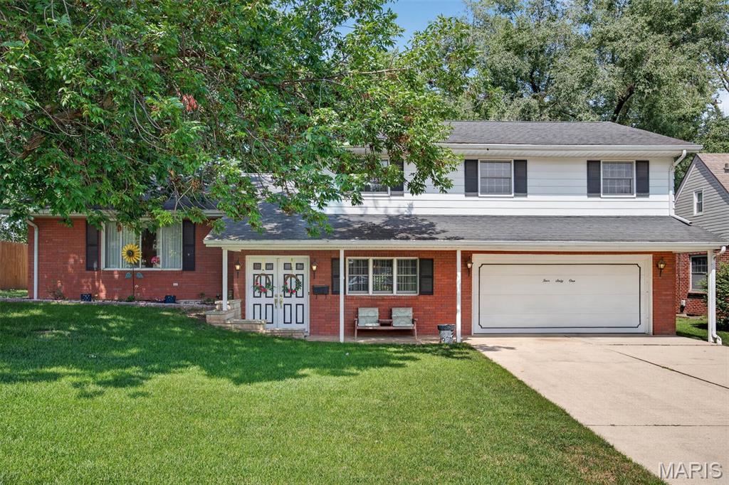 Welcome to this spacious quad-level home offering over 2,000 square feet of living space with room for everyone! The main level features a comfortable family room, a convenient half bath, and direct access to the attached two-car garage. Just a few steps up, you'll find a large living room highlighted by a beautiful brick fireplace, an open dining area, and an eat-in kitchen with an abundance of cabinet space. A bright glass-enclosed sunroom just off the dining area overlooks the large backyard, creating the perfect spot to relax or entertain.

The upper level offers a generous primary suite with its own private full bath, along with three additional bedrooms and a full hall bathroom. The lower level provides even more living space with a spacious rec room and plenty of storage. With its functional layout, generous room sizes, and endless potential, this well-built home is ready for your personal touches. A little updating will make this the perfect forever home for years to come!