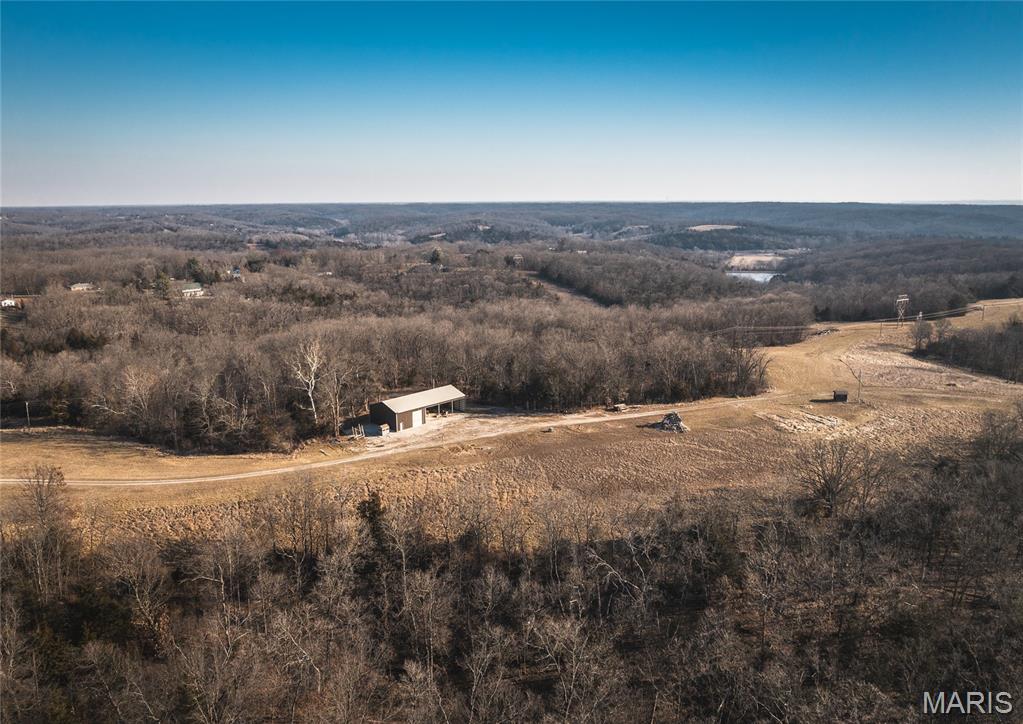 Discover the perfect blend of country living and convenience with this exceptional 19-acre property located just 5 minutes from Jefferson City and right up the road to Railwood Golf Course. Featuring a partially finished shouse, this property offers a fantastic opportunity to customize the living space to your needs while enjoying immediate functionality and comfort.
The shouse is already equipped with cabinetry, counters, appliances, a completed bathroom with vanity, and a large garage door, making it ideal for storage, a workshop, or future living quarters. An attached open-ended shed provides additional space for equipment, vehicles, or recreational toys.
With 19 acres of usable land, there’s plenty of room to build, ride trails, hunt, hobby farm, or simply enjoy the privacy and beauty of the countryside. Properties offering this much acreage, flexibility, and proximity to Jefferson City are hard to find. Whether you’re looking for a homesite, recreational retreat, or investment opportunity, this property is ready for your vision.