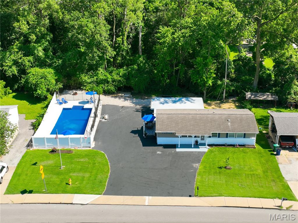 Welcome home to 10808 Midland Blvd.! Proudly situated in a neighborhood served by dedicated first responders; professionally staffed neighbors who help watch over the community.  Situated on a rare DOUBLE LOT in the sought-after Pattonville School District, this beautifully renovated 3-bedroom, 2.5-bath ranch offers the perfect blend of modern updates and outdoor entertaining. Featuring 1,461 square feet of living space, you'll love the refinished hardwood floors, stunning updated kitchen with a gas stove and new cabinets.  Stylishly remodeled bathrooms showcasing new tile, fixtures, and cabinetry. The partially finished lower level provides a spacious recreation room, full bath, and flexible space that could easily serve as a home office, guest suite, or potential fourth bedroom.  Car enthusiasts, hobbyists, and DIYers will appreciate the oversized 3+ car garage with additional workshop/tool room space. Step outside to your own private backyard oasis featuring a massive in-ground pool on the second lot—perfect for hosting family gatherings, summer parties, and creating lasting memories. Recent pool updates include a new liner and new concrete surround.  With all the major updates already completed, there's truly nothing to do but move in and enjoy! This one-of-a-kind property (you would be the second owners) offers space, style, and amenities that are hard to find in today's market. Don't miss your opportunity to make it yours!