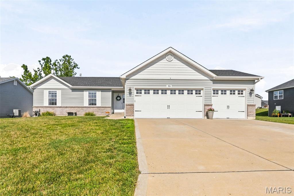 Why deal with the headaches of construction when you can waltz right into this stunning 3-bedroom, 2-bathroom ranch, just 5 years old? With beautiful curb appeal and a covered front porch that practically sings "Welcome Home." With new LVP flooring and fresh paint throughout the main living space, the vaulted ceilings, open floor plan, and fabulous great room flow effortlessly into the kitchen and breakfast nook—a perfect setting for family shenanigans. The kitchen is separated by a butterfly island and decked out with granite countertops, gleaming stainless-steel appliances, a walk-in pantry, and soft-close cabinets with crown molding finishing it off. The MF laundry is as adorable as can be and cozied up next to the three-car garage and kitchen. Down the hall, you will find a generous primary suite complete with a walk-in closet and a private bath featuring a double vanity, seated shower, and ample linen storage. Two more roomy bedrooms and another full bath round out this fabulous abode. Step outside to an adorable patio—perfect for grilling your favs, unwinding after a long day, or channeling your inner outdoor enthusiast. And if you’re dreaming of extra space, you are in luck - finishing the lower level, equipped with a 3/4 bath rough-in and egress window, is already underway awaiting your finishing touches just begging for your personal flair. Nestled on a prime lot in Wright City, this home is just a hop, skip, and a jump to Highway 70, making your commute effortless.