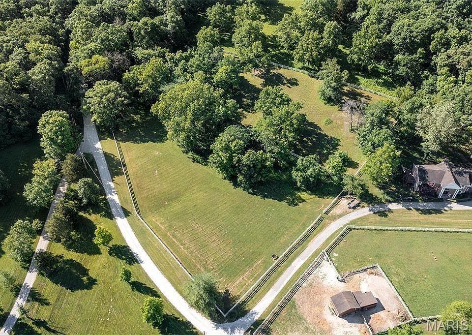 Amazing Improved Price!!! This is it! Bring your horses! One-of-a-kind Opportunity in Pinhook Hollow in Wildwood! Discover over 3+ acres of pristine, build-ready land in this exclusive 5-home enclave nestled among the trees of Rockwoods Range. Fully fenced, the property offers two distinct areas for endless possibilities—envision your dream home on the upper portion, perfectly suited for a walkout design, while the lower acreage is ideal for a barn, pasture, workshop, or additional garage. With allowance for up to three horses, this setting is perfect for those seeking space, flexibility, and privacy. Surrounded by picturesque pastures and mature trees, enjoy breathtaking sunsets and a peaceful, tucked-away feel. Located directly across from Greensfelder Park, with access to over 3,000 acres of hiking, biking, and horseback riding trails. Situated in the award-winning Rockwood School District and just minutes from local shopping and access to Highway 44, this location offers the perfect blend of seclusion and convenience. Complete survey and subdivision indentures, soil testing, excavation, septic & well bids. A truly rare opportunity to build your dream lifestyle at 18324 Pinhook Hollow Drive!