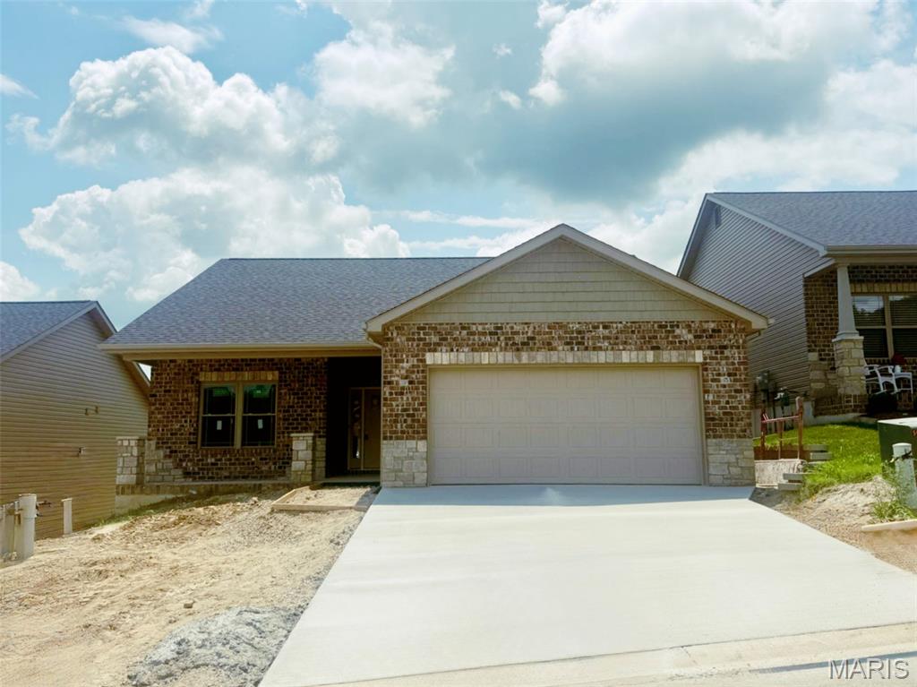 Discover a truly worry-free lifestyle in this brand-new home in Tanglewood’s 55+ community of Villa Valley. Built by Juliet Alpha Properties, this home showcases their signature style with distinctive window casings, designer shelving, durable LVP flooring, and abundant LED and smart motion-activated lighting. The 2-bed, 2-bath, 1,446 sq ft main level feels bright and inviting with an open layout, quartz countertops, 42" soft-close custom cabinets, a vaulted great room, a gas fireplace, and a zero-entry from garage to home. The primary suite offers a large cultured marble shower with bench, dual vanities, and a walk-in closet connected to the laundry room for everyday ease.  The lower level is unfinished and includes an egress window, a bath rough-in, & is full of possibilities. Energy efficient, lifetime basement waterproof warranty, some ADA compliant features, & so much more! Enjoy mornings on the covered deck, or grab your fishing pole and wander down the street to one of Tanglewood’s stocked lakes—just a few steps to the water and trail. Then lock the door and head out of town without a second thought. Lawn care, snow removal, irrigation, and seasonal yard clean-up are all included for only $125/month. Photos shown are of a previously built home by Juliet Alpha Properties.  Finishes will be similar.  This home may be different based on floor plan, customizations, options, and upgrades.  Estimated completion date is July 2026.
