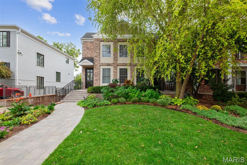 Welcome to this wonderful home nestled in a fantastic Clayton neighborhood. This home has a lock & leave convenience that makes it appealing for those looking for a townhome as well.  The lush, professional landscaping greets you and immediately you can feel the sophistication of the home.  Upon entering, you will notice the white walls, gleaming hardwood floors and charming millwork.  On your right you will find a formal powder room, beautifully wallpapered and an office/den just beyond that.  There is a large living room adjacent to the office that offers built-in cabinetry, a gas fireplace and access to a spacious screened-in porch.  A lovely dining room is beyond the living room and conveniently located near the kitchen.  The kitchen offers neutral tones, plenty of storage and stainless appliances.  The laundry is conveniently located off the kitchen, along with a 2nd powder room.  Great for grilling, there is a deck off the kitchen overlooking the fenced-in rear yard.  Take the ELEVATOR or the stairs and you will find the generous primary suite with a walk-in closet and large bath.  There are 3 secondary bedrooms all with great closet space, and two full baths.  The lower level has a space that could be a recreation room or a gym, it also has a full bath.  Walkout to the garage and heated driveway from the lower level.  Finally, with walkability to schools, Shaw Park, Straubs, shopping and restaurants, what more do you need?