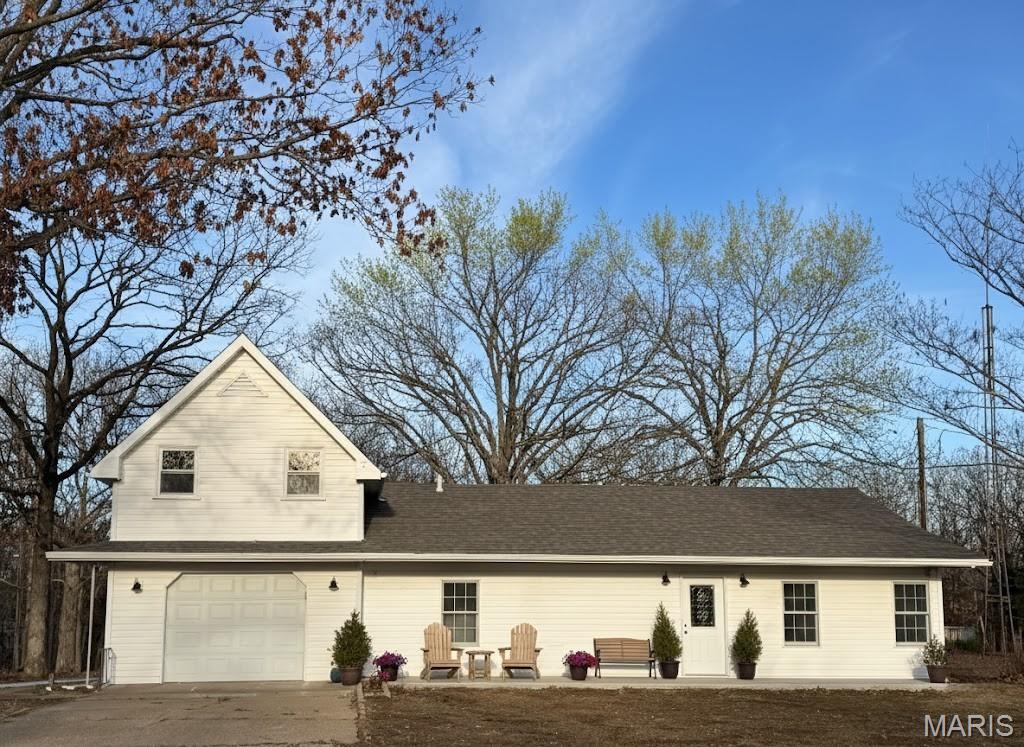 Rich in charm and personality, this home offers a delightful cottage-core aesthetic with custom, handmade touches that add warmth, character, and timeless appeal throughout the space. Welcome to 2803 Highway J in Bourbon, this move-in ready 1.5-story home situated on 3.13 picturesque acres, offers the perfect blend of space, comfort, and convenience. This thoughtfully designed divided floor plan provides both privacy and functionality, ideal for everyday living or entertaining. Property features new roof, siding, garage door, gutters, soffit and facia. New flooring and trim throughout. Freshly painted interior, new interior doors. New air conditioning unit, new A coil in furnace, new pressure tank and new septic in 2024.

The home features a spacious, open-concept kitchen with custom handmade cabinetry. Living area filled with natural light and highlighted by beautiful natural wood details throughout. The updated kitchen and bathrooms offer modern finishes while maintaining a warm, inviting feel.

Enjoy the peace of country living with the convenience of being less than 3.5 miles from I-44, making commuting and travel a breeze. The expansive lot provides endless possibilities for outdoor enjoyment, hobbies, or future expansion. Property features shop equipped with electrical service and concrete floors, ideal for storage or workspace, in addition to an auxiliary structure with concrete flooring, perfect for a potting shed, equipment storage, etc.

This move-in ready property combines comfort, space, and location — a rare find with room to grow.