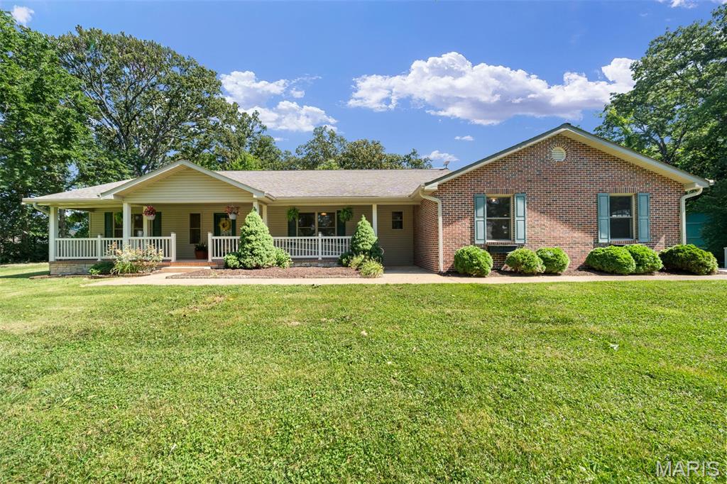 Enjoy the best of country living in the highly sought-after Waterloo School District, just a short drive from Waterloo, Columbia, and the St. Louis metro area. Nestled on over 4.44 scenic acres, this renovated move-in-ready reimagined ranch offers more than 2,600 square feet of main level living space plus approximately 1,800 finished square feet in the lower level, combining modern updates, ADA accessibility features, heated floors and peaceful rural surroundings.

The beautifully remodeled kitchen features white cabinetry, butcher block countertops, a stylish backsplash, and an open flow to the dining room, breakfast room and adjoining sitting room/sunroom, creating the perfect space for entertaining, relaxing with picturesque country views. The kitchen also provides seamless access to the covered porch and paver patio, ideal for BBQs, morning coffee, evening drinks, and gatherings with family and friends.

Outdoor spaces are designed to impress with a tranquil waterfall feature, outdoor fireplace and multiple places to relax while enjoying sweeping views of the surrounding countryside. Whether you're hosting guests or simply unwinding after a long day, this property offers the peaceful lifestyle you've been searching for.

The reimagined floor plan offers 5 bedrooms and 2.5 baths, including 3 spacious bedrooms on the main level and 2 additional lower level bedrooms with egress windows. The private primary suite provides direct access to the porch and features dual vanities, wide doorways, a walk in shower, and a large ADA-accessible jetted tub with custom closet. Convenient main-floor laundry and numerous ADA-friendly features throughout the home, including ramps, add comfort and accessibility.

The finished lower level expands your living space with a large recreation room perfect for gatherings, hobbies, gaming, or movie nights. An expansive unfinished storage and workshop area offers endless possibilities for additional finished living space, a fitness room, media room, home office, guest suite, or hobby area.

Recent improvements include remodeled bathrooms, bedrooms, flooring, fresh paint throughout, an updated kitchen, a new French drain system, and sump pump. Energy-efficient geothermal HVAC provides year round comfort climate and cost saving benefits.

A large attached 2 car oversized garage with ramp access provides easy entry and ample space for vehicles and storage. The substantial outbuilding/workshop area with separate electrical panel service offers exceptional flexibility for farm equipment, ATVs, recreational vehicles, workshop space, farming, or storage needs.

The 4.44+ acre property includes four apple trees, a peach and plim tree, large pasture and open field areas for your own "Field of Dreams" ideal for horses, livestock, gardening, hobby farming, recreation, sports, or future solar opportunities. Several fruit trees are already established and ready to enjoy.

Offering the privacy and serenity of country living with convenient access to the St. Louis metro area, this exceptional property is truly renovated move-in ready with space, versatility, accessibility, and a lifestyle rarely found in today's market. Properties offering this combination of acreage, updates, geothermal efficiency, outbuildings, accessibility features, and proximity to Waterloo and St. Louis are hard to find. With nothing left to do but smile, move in and enjoy, this is an opportunity you won't want to miss. Schedule your private showing today and experience firsthand how easy it is to make this remarkable property your forever home. MOTIVATED SELLER.