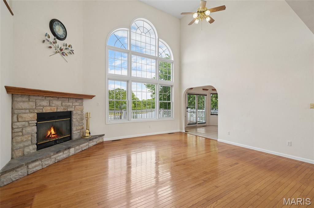 4-bed/5-bath/3 car garage & carport on the lake & offering 4,200+/- sq ft of thoughtfully designed living space on 2 landscaped lots in a gated community with stunning Summer Set Lake views. Natural light filters through the gorgeous Palladian window highlighting 18’ ceilings and stone wood-burning fireplace. The kitchen features abundant cabinetry, ample counter space, and a breakfast nook with lake views, plus a formal dining area. The main-level primary suite is a retreat with hardwood floors, coffered ceiling, deck access, and a newly updated en suite with jacuzzi tub, walk-in shower, double vanity, TV, and lake-view bay window. Upstairs includes a second primary suite with a private bath, a lovely sitting area, plus two additional bedrooms and a shared full bath. The finished lower level is built for entertaining with stunning bar area with custom copper countertops & separate kitchenette equipped with matching Galanz refrigerator and microwave, theater seating for 8 (100” screen, Bose sound), billiard room, and soundproof studio that could easily be a quiet, cozy home office space. Outdoor living shines with a gazebo deck, in-ground heated/cooled pool, new 2025 hot tub, cooking areas and expansive decking. A private 25’ x 22’ dock with boat slip and slide completes the experience. Additional features include EV hookup, copper plumbing, upgraded smart-entry doors, new Roof Summer 2025, and 1-year-old dual HVAC. A rare luxury lakefront property designed for year-round enjoyment. 
Many personal property items also included. 
This one-of-a-kind lakefront home seamlessly blends elegance, recreation, and luxury—offering a rare opportunity to own a premier property designed for making memories year-round.
