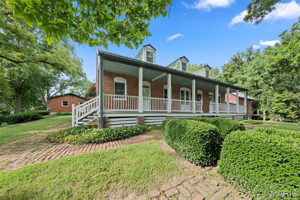 Welcome to 205 East 8th Street-a rare 1852 Historic home on over 5 acres spanning 30 city lots! This 3 bedroom, 2 bath property offers a unique blend of historic charm, privacy, and prime location just blocks from downtown Hermann. Inside you'll find original character throughout, including a wine cellar, spacious rooms, and vintage details. Outside features a covered front porch, covered patio, open green spaced, and a rustic old smokehouse--all surrounded by mature trees for peaceful seclusion. Lots range from Commercial to R-1 zoning, offering flexibility for future use. This is a great investment opportunity or the perfect home for someone who values space, heritage, and potential. Whether you are seeking a private residence, weekend getaway, or future development, this property is truly a must-see. Don't miss the chance to own a one-of-a-kind piece of Hermann's rich history! Call today for a showing and find out about the deep history of 205 East 8th Street!