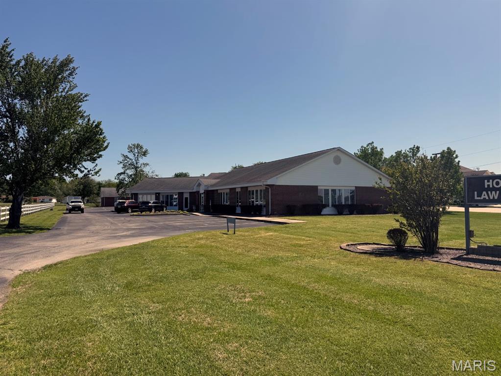 Prime commercial opportunity featuring two separate all-brick buildings situated on a single parcel totaling approximately 1.245 acres. With a combined square footage of around 10,000 +/- square feet of office space, this property offers versatility for both investors and owner-users alike. The front building is currently operating as a law office, providing a turnkey professional space. The rear building is vacant and ready for occupancy, offering flexibility for additional leasing opportunities or business expansion.  This property may be purchased as a whole or divided, with each building being available for individual sale or lease.  The front building is offered at $1,255,000 and the rear building is $495,000. In the event of a separate sale, an easement will be established to provide access to the rear building.  Both structures are well-maintained and benefit from ample on-site parking, accommodating clients and staff with ease. Positioned along high-traffic Business Highway 60, the property boasts excellent visibility and road frontage, ensuring strong exposure for any business.