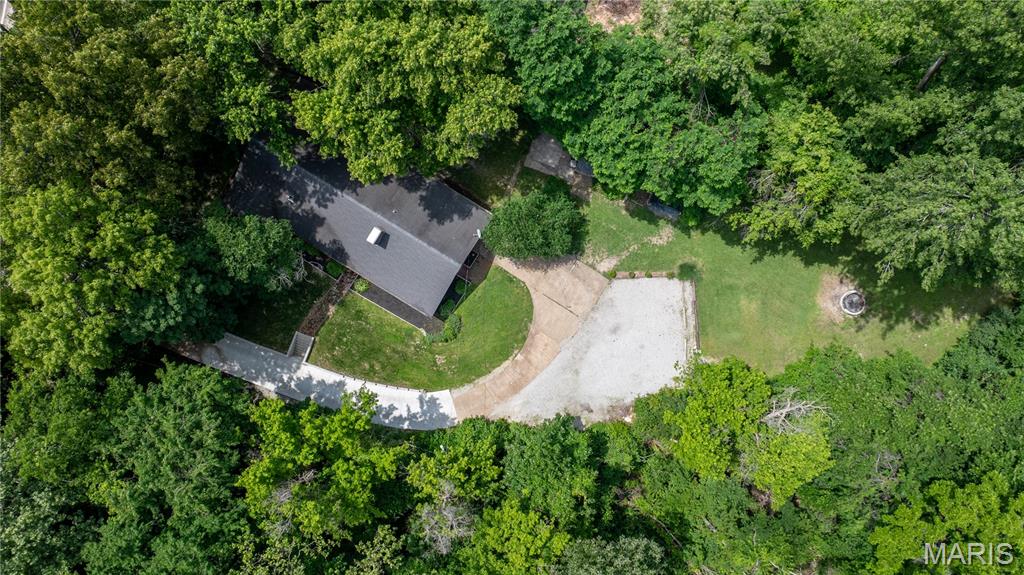 Calling all homesteading and gardening enthusiasts! Charming and well-maintained brick ranch situated on 1.12 acres adjacent to sprawling conservation area, offering the perfect blend of peaceful country living and everyday convenience. Surrounded by a scenic, woodsy setting, this 3-bedroom, 2-bath home delivers space, comfort, and rustic charm both inside and out.

Step inside to find a large open floor plan featuring two spacious living areas connected by a stunning double-sided stone fireplace that creates a warm and inviting centerpiece throughout the home. The living room and dining room combo offers an ideal space for gathering, entertaining, or simply enjoying everyday life. The kitchen provides an abundance of cabinet space, making storage and functionality a breeze. You'll appreciate the added space of a bonus room that can be used as a workshop or office. 

Outside, the property continues to impress with plenty of room to relax and enjoy nature. The large outdoor fire pit area creates the perfect setting for evenings with family and friends while taking in the peaceful surroundings and views of the nearby wildlife abundant conservation area. Several storage areas on the property including two sheds as well as a quonset hut for all the outdoor enthusiasts equipment. 

With its spacious layout, beautiful natural setting, wildlife viewing, and close proximity to nearby amenities, this property offers the ideal combination of privacy, comfort, and convenience. Freshly painted with newer light fixtures throughout, this one is move-in ready. Opportunities to own a property like this don’t come around often.