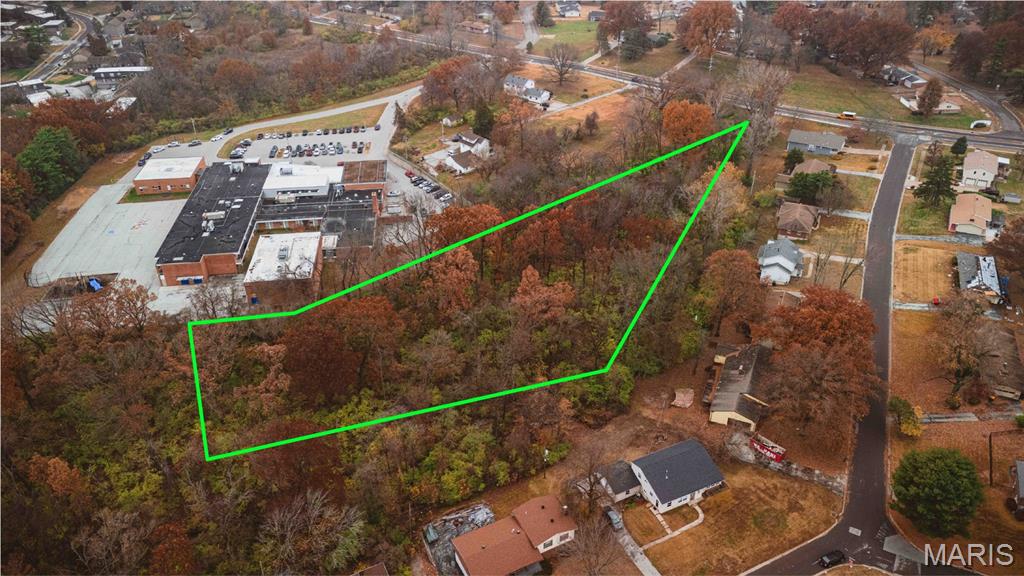Unique Opportunity — Buildable R-2 Lot Backing to School & Residential Neighborhoods. Discover a rare piece of land in North County with serious potential. 

This parcel offers a mix of challenges and opportunity—perfect for the right buyer with creativity and vision. This deep lot features a significant slope, giving the appearance of being landlocked at first glance. However, two legal easements provide access to the property, and St. Louis County has confirmed the zoning as R-2 Residential, meaning the lot is eligible for future construction. While the slope will require thoughtful planning and engineering, the land remains fully buildable under County guidelines.

The fully wooded property directly adjoins Townsend Elementary School and backs to established residential homes, creating a unique buffer of privacy with no backyard neighbors. Whether you envision a custom hillside home, a long-term hold, a recreational space, or even a strategic play for future development, this parcel offers multiple directions for the right investor or builder.

This is not your average flat suburban lot—but that's exactly where the opportunity lies. The parcel lines on the photos are best estimates and not from a survey. If you're looking for an affordable piece of land with upside, privacy, and flexibility, this one deserves a closer look. Bring your builder, your engineer, or your imagination.

Opportunity meets creativity—come see what’s possible