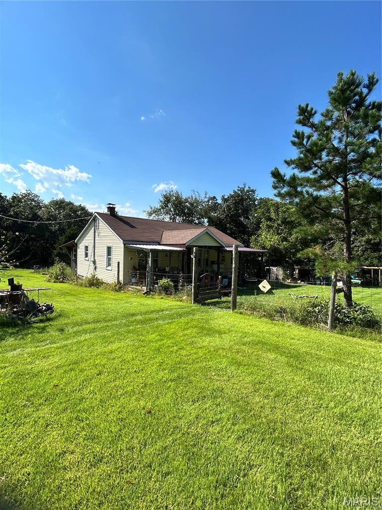 Rustic Secluded retreat on 3+ acres! Escape to your own private country sanctuary with remodeled rustic-style home nestled on 3 acres m/l. The fenced front yard welcomes you to a property surrounded by nature, privacy, and abundant wildlife. Inside, the remodeled kitchen blends rustic charm with unique character, featuring beautiful cedar log accents, an antique porcelain sink, custom cedar countertop, barn wood for shelving. Original hardwood flooring adds warmth and timeless appeal throughout the home. The back of the home offers an enclosed porch, perfect for relaxing and taking in the peaceful surroundings. Step outside and discover your own private orchard, featuring a variety of fruit and nut trees including peach, crabapple, cherry, pear, pecan, wild native plum, red & white mulberry and 4 types of berries, blueberry, thornless blackberry, raspberry and large sections of elderberry. The property also includes a natural artisan spring well. Great location only 6 miles from Tom Sauk Reservior & lake to fish and only 15 miles to K bridge and the Black River. So many trails and recreational possibilties!