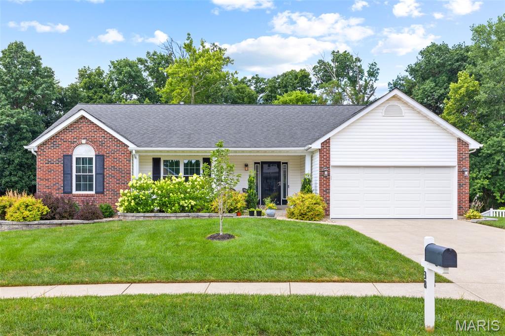 Who's looking for an updated brick-front home on a quiet cul-de-sac backing to woods and common ground?! This spacious home features an open floor plan w/ a walk-out basement, vaulted great room, primary suite & upgrades galore. The great room is highlighted by a wood-burning marble fireplace, new main-level windows w/ an abundance of natural light & engineered hardwoods throughout the main living area. You'll find new carpet in all 3 main bedrooms & luxury vinyl flooring in the bathrooms & main-floor laundry room. The kitchen offers custom white cabinetry with updated hardware, a center island/breakfast bar, pantry, stainless steel appliances & a bright breakfast area. The vaulted primary suite, including a walk-in closet, double vanity, garden tub & separate shower, is every homeowner's dream. The finished walk-out lower level adds extra square footage w/ an entertainment room, 4th bedroom, full bath, plenty of storage & French doors leading to the backyard. Enjoy the private, tree-lined yard from the Veka composite deck (2019) or shaded patio. Additional updates include a newer furnace and A/C (2023), 50-gallon water heater (2024), plus fresh landscaping including Green Vase Zelkova & Judy Zuk Magnolia trees. Ask your agent for a list of other improvements! Don't forget the 2 car garage with a 3-foot bump-out, epoxied floor & fully drywalled. You can't beat the location...minutes from 94, shopping, dining, entertainment, Francis Howell School District, you name it!