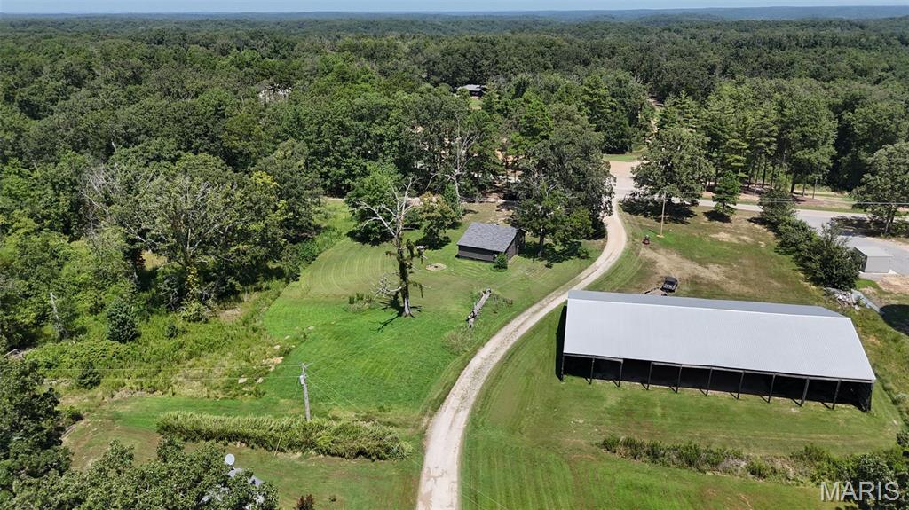 Discover the perfect blend of comfort and outdoor opportunity with this cute, updated 2-bedroom, 1-bath home situated on 9.4 (+/-) beautiful acres. The property features convenient boat storage, established campsites, and electric meters already in place—offering endless possibilities for camping, recreation, guests, or additional income potential. Whether you're looking for a peaceful country retreat, weekend getaway, or property with room to grow, this one is ready to enjoy!  Seller will subdivide.