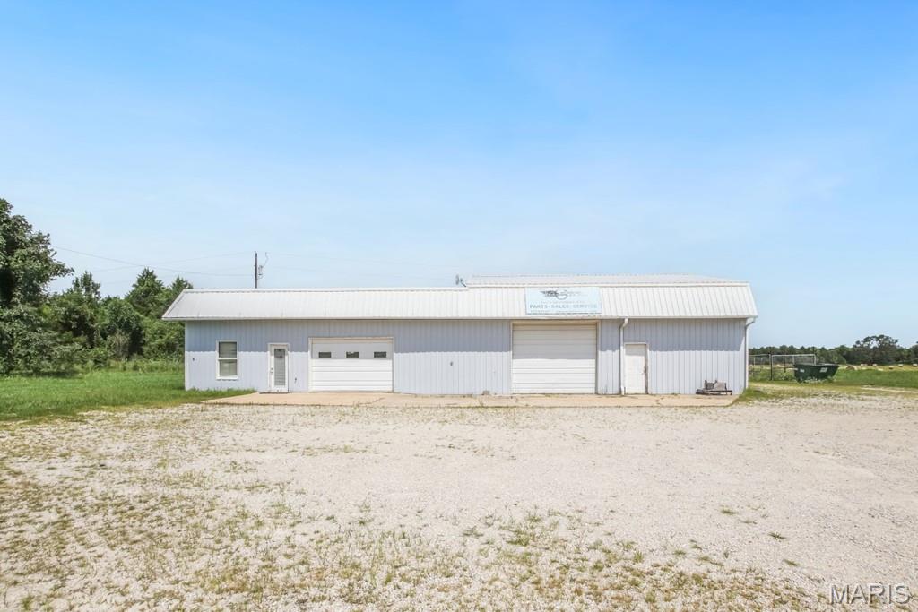 Located at Exit 210 with approximately 136+/- feet of Interstate 44 frontage, this 3,252+/- square foot commercial building offers excellent visibility and convenient access for a variety of business operations. The metal building features a finished interior with office space, a restroom, and a climate-controlled shop equipped with two propane heating systems and a mini-split system. The shop is equipped with air compressor lines run throughout the building, two overhead garage doors, and a fenced rear storage area, making it well-suited for equipment, vehicles, and materials. Originally constructed in 1973 with an addition completed in the 1990s, the property provides a functional layout for contractors, landscaping companies, towing operations, service businesses, warehouses, or anyone needing shop and storage space with quick access to I-44. Its high-visibility location and easy interstate access make this a practical opportunity for businesses looking to expand or establish a presence along one of the area's busiest corridors.