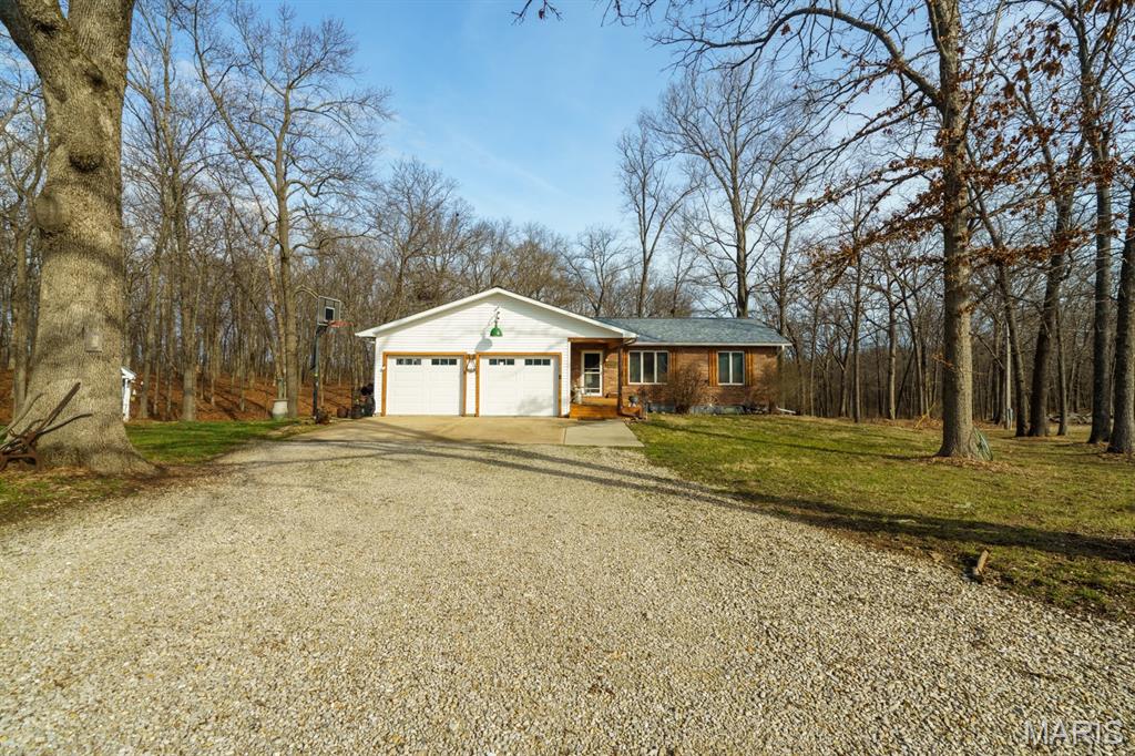 Want privacy yet in town?!  12.4 acres right inside the city limits, part open with some fencing and the rest is wooded. Room for a few cows or a horse!  This is a unique home with lots of vintage touches including a newel post at the basement stairs that came from the Rolla building at MS&T campus, antique door on the foyer coat closet, barn boards from a barn in Wesco, MO, barn doors from an old farmhouse where I grew up, antique tin ceiling from a mansion in St. Louis and many other small touches.  Ranch home has had tons of updates in the last few years, new roof, new siding, new deck was recently done. Nice open feel, vaulted ceilings, big master bedroom with a big walk-in closet and a private bath.  Walk-in pantry and laundry hook ups on both levels. Newer range and dishwasher, big farmhouse style sink and a breakfast bar in the kitchen. Basement is completely finished with a full bathroom, huge family/rec room, utility/work room and 2 walkouts to the lower patio. There's room for 2-3 other bedrooms in the lower level if you wish.  36X24 shop building with 36X12 lean-to at the back is insulated, has electric and concrete floors, Playhouse, lean-to outbuilding and a log cabin doghouse with a large, fenced dog pen. Owner is a license real estate agent.  Survey has been done and corners are known.  This is a great house!