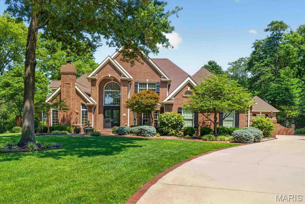 YOU WILL LOVE THIS EXCEPTIONAL CUSTOM-BUILT HOME IN THE ORCHARDS GOLF COMMUNITY THAT BACKS TO THE 18TH GREEN. This spacious floor plan offers timeless elegance and resort style living. Thoughtfully updated with newer hardwood flooring, soaring ceilings, floor-to-ceiling windows, four fireplaces, fresh paint, custom millwork, and a beautifully renovated kitchen featuring Wolf appliances, marble countertops and inset cabinetry. There is also a butler’s pantry with ice maker and a formal dining room, perfect for entertaining. 

The vaulted hearth room and elegant formal living spaces are ideal for entertaining, while the luxurious primary suite offers dual walk-in closets and a spa-inspired bath with a steam shower and jetted tub. The finished walk-out lower level is an entertainer's dream, featuring a fully equipped wet bar with ice maker, spacious recreation space, bedroom with cedar closet, exercise room, custom built-ins and abundant storage. 

Step outside to your private backyard retreat, thoughtfully designed for both entertaining and everyday relaxation. Enjoy the saltwater pool with waterfall and diving board, expansive stone patios, a fully equipped outdoor kitchen and a covered pergola featuring a fireplace and electric heater, all surrounded by professionally landscaped grounds. The detached pool house offers a full kitchen, full bath, generous storage, convenient laundry, while the detached golf cart garage provides additional space for vehicles, equipment or hobbies.

Additional features include a library, upstairs home office, whole-house generator, built-in surround sound system, full brick exterior, oversized garage and exceptional craftsmanship throughout. A rare opportunity to own one of The Orchard's most remarkable homes. Convenient location, close to clubhouse, golf, and interstate access. MUST SEE!