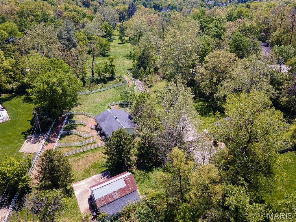 Tucked behind a canopy of mature trees, this extraordinary 6.51-acre sanctuary sits squarely in one of Town and Country's most coveted corridors, providing ultimate privacy and endless opportunities. Whether you envision a world-class equestrian estate or a bespoke private residence, the land delivers the canvas—and the infrastructure—to make it happen.
 
Equine amenities are already in place, including a 6-stall barn with paddocks, a wash stall, and tack room (with bathroom), plus a spacious equipment shed. A charming 2-story farmhouse with 4 bedrooms and 2 bathrooms offers comfortable accommodations while you plan your vision.
 
Horse lovers will appreciate the direct, road-free access to Queeny Park—564 acres of trails for riding, hiking, and exploring right at your doorstep. Despite the serene, countryside feel, the location keeps you effortlessly connected to major highways, top-rated schools, medical facilities, and premier dining and shopping.
 
Discerning buyers will recognize just how rarely a parcel like this comes to market. Make sure you view the video tour that showcases everything this remarkable property has to offer.