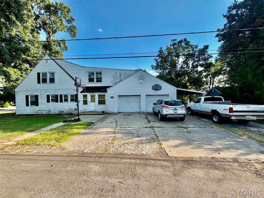 This one has the space, versatility, and plenty of extras!  Located on a desirable corner lot, this home offers a 2 car attached garage, additional carport with storage, two wood burning fireplaces perfect for cozy evenings and gathering with family and friends.  The family room in the basement is perfect for movie nights, entertaining or simply relaxing.  Bonus room off the foyer, ideal for a home office, study, craft room, or whatever fits your lifestyle!  There's so much potential here.