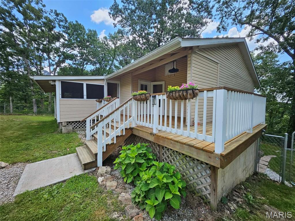Country living with the convenience of town just minutes away! Located in the highly sought-after Waynesville R-VI School District and only a short 10-minute drive to Fort Leonard Wood, this home offers the perfect blend of space, comfort, and location.

As you arrive, you'll be greeted by a large, level front yard, a welcoming screened-in front porch, and a fenced backyard play area perfect for kids, pets, or outdoor entertaining.

Inside, the main level features a spacious living room, a large kitchen and dining area with plenty of room for gathering, a full bathroom with laundry hookups, and an oversized bedroom complete with two closets.

The lower level offers even more living space with two oversized bedrooms, a full bathroom, and a cozy family room with direct access to the backyard.

If you're looking for room to spread out, enjoy a little extra privacy, and still be close to schools, shopping, and Fort Leonard Wood, this home is a must-see!