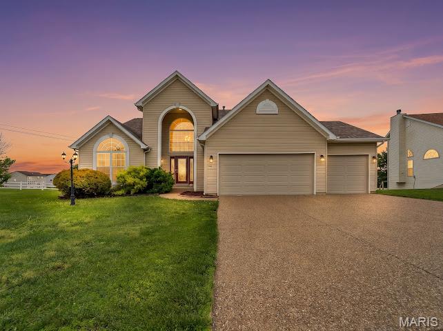 This spacious home offers room to spread out both inside and out with a finished walkout lower level, oversized living areas, and a backyard designed for relaxing and entertaining. The exterior features attractive curb appeal, a 3-car garage, and a covered upper deck overlooking the yard. Inside, you’ll find soaring ceilings, large arched windows that bring in natural light, and multiple living and dining spaces. The primary suite includes a spacious bathroom with dual vanities, soaking tub, and separate shower. The finished walkout basement provides additional living space perfect for a family room, recreation area, home office, workout room, or guest setup. Enjoy outdoor living from the screened/covered deck and lower patio area with plenty of yard space to enjoy. Conveniently located in Wentzville with easy access to shopping, dining, schools, and major highways.