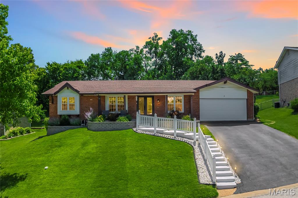 Open Sat, 6/27, 10am-12pm. Some homes just live well, and this one is a perfect example. Tucked on a quiet cul-de-sac in the sought-after Danbury neighborhood, 556 Sprague Mill Court offers the kind of lifestyle that's hard to replicate: top-rated Rockwood/Marquette schools, a neighborhood pool just steps away, and easy access to Ballwin Golf Course and Event Center, Vlasis Park, and all the dining and conveniences Manchester Road has to offer.

The backyard sets the tone. A large concrete patio with a curved sectional, fire table, and hot tub creates an outdoor living space that feels more like a resort than a suburb. The fully fenced yard with mature trees offers privacy and room to play, and the built-in outdoor kitchen with a gas grill and bar seating makes entertaining effortless from the moment the weather turns. The roof was replaced in 2025, all main level windows were replaced with triple-pane glass in 2024, and the gutters have leaf filter screens, so the big-ticket items are already done.

Inside, the sellers completed an extensive main floor remodel that touched nearly everything: new laminate flooring throughout the main level, updated electrical including a 200-amp panel, all new interior doors, fresh paint on every wall and ceiling, and a redesigned fireplace with stone surround and insert. The kitchen was further elevated in 2025 with quartzite countertops, a new backsplash, a farmhouse sink, and updated appliances. The open living area features a fireplace, recessed lighting, and sliding doors that pour in natural light and connect directly to the patio. A formal dining room with crown molding and a statement chandelier rounds out the main living spaces nicely.

The primary suite is spacious and well-appointed, complete with a remodeled bath featuring onyx shower panels, a 60-inch vanity, and tile flooring. The additional bedrooms are well-sized and flexible, and a dedicated home office with crown molding, recessed lighting, and hardwood floors works just as well as a fourth bedroom. The updated hall bath features a marble-top vanity and tiled tub surround.

The finished lower level adds significant living space, with a long open rec room, recessed lighting, and room for whatever you need it to be.

Out front, the tiered retaining walls and flower beds were replaced in 2023, giving the home a polished, low-maintenance curb appeal that matches the care put into everything inside.