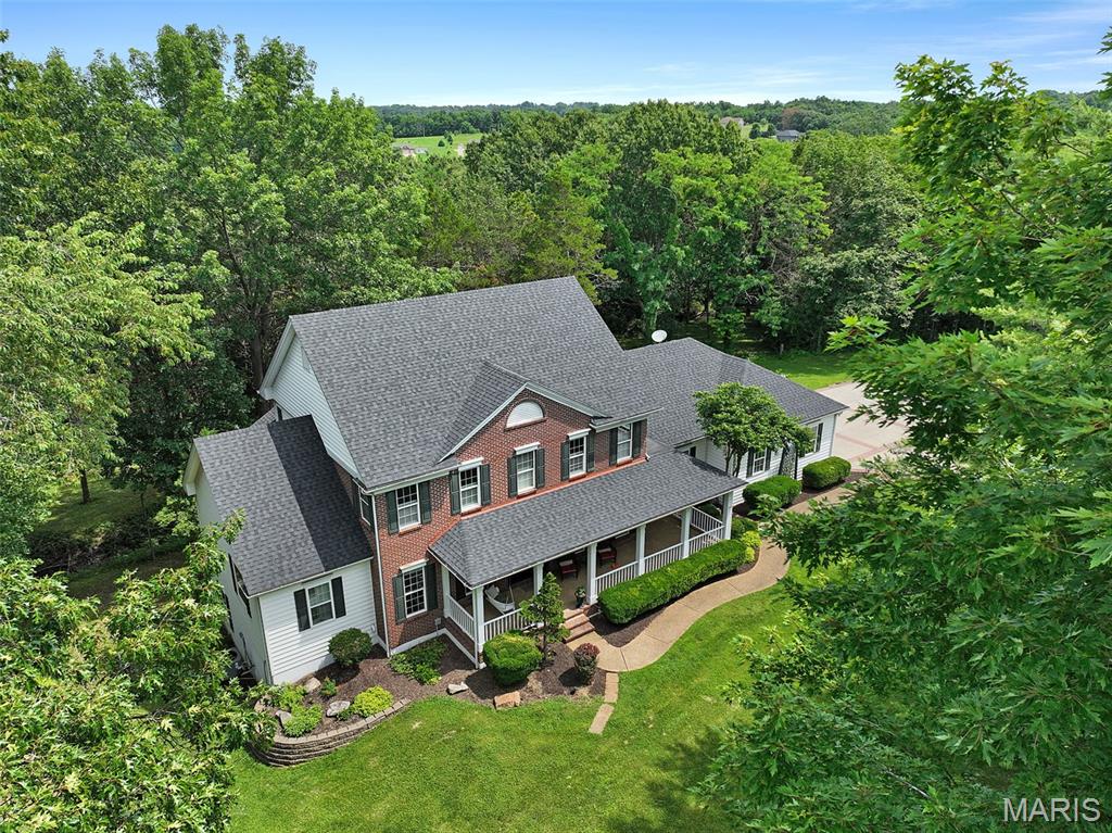 5 Acres! New Roof! Did we get your attention? Let us tell you about 4305 Green Briar Ct. Located just outside of city limits of Washington, MO, this well-appointed custom home has been lovingly taken care of. The custom details will impress you and make your next move so exciting. Tucked away at the back of the cul-de-sac, this impressive 3100+ square foot home offers lots of space in addition to an additional (1000 sqft +/-) finished lower level. The main floor greets you right from the covered front porch into the inviting entry foyer donning inlaid wood floors and massive windows that look out at the back of the home. To the left is the library, to the right is the formal dining room. Step into the great room and experience the expansive tall ceilings, gas fireplace and look above to the open 2nd floor. Custom crown molding is the perfect finishing touch here. Enjoy preparing meals in the kitchen with lots of windows and natural light along with granite and Corian tops, marble and decorative tile, a Thermador 5 burner gas stove top, wall oven, built in microwave and spacious pantry. But wait!!! There is also a butler’s pantry that is perfect for entertaining and more prep and storage space with exterior access to the front porch. The laundry room is oversized and right off the entrance of the 3-car garage. The primary bedroom is on the main floor, again with lots of natural light, walk-in closet and spacious bathroom with separate vanities, separate shower and tub. Upstairs is perfect for guests or a growing family with 2 spacious bedrooms and a playroom or whatever you can imagine. The first bedroom up the stairs also offers a nice walk-in closet and then inside there, a (2nd) cedar-lined walk-in closet! It’s amazing! Both bedrooms share an adjoining bathroom. The finished lower level includes another nice spacious bedroom, family room, office are and loads of storage, even hidden storage. Your agent can inquire. Private 5-acre parcel offers both open ground for the front, side and rear of the home with a wooded tree line to the back and sides with walking trails!