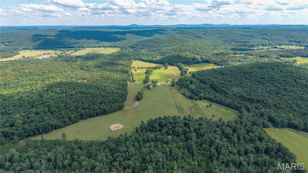 Escape to the heart of the Ozarks with this exceptional 93± acre farm surrounded by the beautiful rolling mountains of Madison County. Conveniently located with access off Madison 515, this versatile property offers approximately 45 acres of fenced pasture, with the balance in timber, making it an ideal setup for livestock, recreation, or a country homestead.

The mostly updated 3-bedroom, 1-bath home features new flooring, an updated bathroom, new windows, and a newer HVAC system, providing modern comfort while maintaining its rural charm. Multiple spring-fed ponds are scattered throughout the property, offering a reliable water source for livestock and enhancing the beauty of the landscape.

Currently operating as a cattle farm, the property is well-equipped with a 30' x 40' barn featuring a concrete floor and electricity, providing excellent space for equipment, storage, or workshop use. Outdoor enthusiasts will appreciate being just minutes from Marble Creek Campground and Trailhead, with convenient access to thousands of acres of Mark Twain National Forest, offering exceptional opportunities for horseback riding, hiking, hunting, ATV riding, and year-round outdoor recreation.

Whether you're looking to expand your farming operation, establish a hobby farm, enjoy outstanding hunting and recreation, or simply experience the peaceful Ozark lifestyle, this diverse property offers endless possibilities in a truly scenic setting.