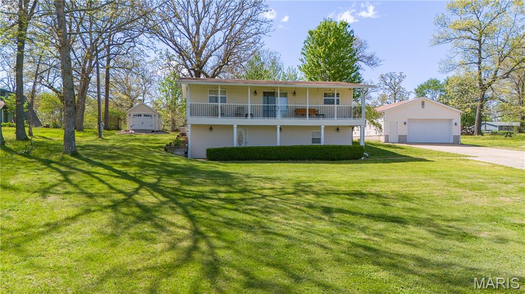 You're going to love this view of the lake! 3 bedroom, 2 bath home located in the gated community of Indian Hills Subdivision. Living/dining room area leads to full front of home length covered deck with wonderful lake views. Or you can step out back for a private tree lined entertaining. Kitchen has stainless appliances that will remain. In the lower level is laundry, extra storage and bath. Exceptional storage in your detached oversized garage with 10' ceilings, window a/c and electric heat. Home is accessible with chair lift between main level and lower level. Indian Lake is a 326 acre recreational gem with fun for the whole family. Ski, kayak, boat, fish or float on the water or play tennis, pickleball, basketball or shuffleboard at the community center. Dedicated community beach access. Full service marina on site. Just over an hour from the greater St Louis area.