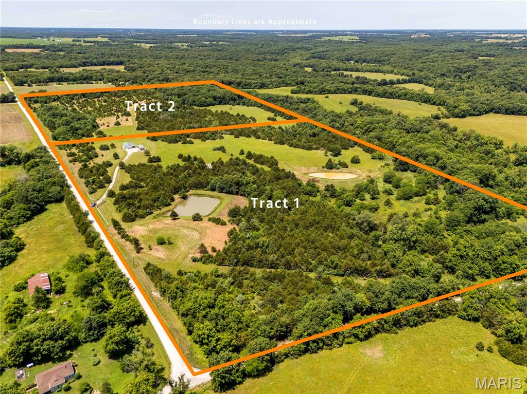 AUCTION LISTING - List price is not indicative of Seller’s final reserve amount.  This property is part of an online bidding event.  This sale will be executed with a no-contingency contract provided by brokerage representing the Seller. See MLS Supplement Document for complete details. These 78.4; flat to gently rolling acres offered in 2 tracts are conveniently located in Ralls County, MO just 5 miles from Spalding Boat Ramp on Mark Twain Lake. This diverse property features open native grass fields, mature woods, cedar trees, and two ponds. Excellent hunting with established deer stands and blinds, plus abundant wildlife including deer, turkey, quail, and rabbits. Improvements include a metal building with storage and a small finished area with a kitchenette and toilet, private septic, public water, and a concrete pad with large carport and camper hookups. Conveniently located just 1 hour 20 minutes from Wentzville.