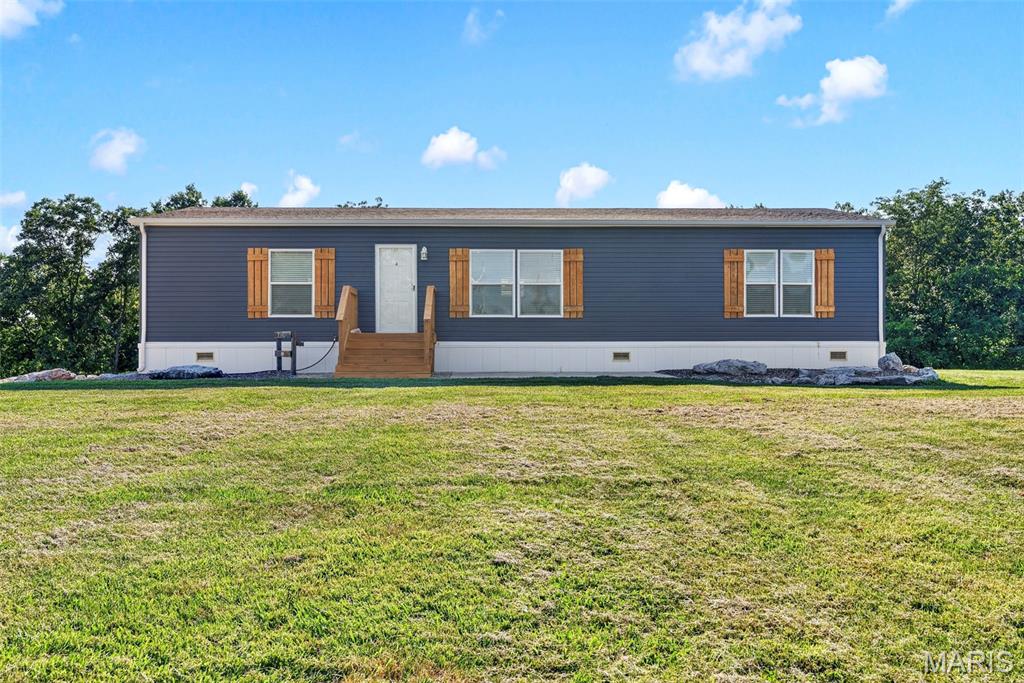 Escape the hustle and enjoy the freedom of country living at 845 Highway EE in Winfield, Missouri. Situated on 2.76 beautiful acres of unrestricted land in unincorporated Lincoln County, this beautifully maintained 2021 manufactured home offers modern comfort, privacy, flexibility, and an outdoor lifestyle that is increasingly hard to find.
Inside, you’ll find a bright, open-concept floor plan filled with natural light and thoughtfully designed for comfortable everyday living. Built in 2021 and completely move-in ready, the home provides the peace of mind of newer construction while allowing you to begin enjoying the property from day one.
The land is what truly sets this property apart. With 2.76 usable acres, there is plenty of room to garden, entertain, build a workshop, store recreational equipment, or simply enjoy the privacy and open space. Located in unincorporated Lincoln County, the property offers the flexibility of country living while remaining within a convenient drive of nearby shopping, dining, and other amenities.
Outdoor enthusiasts will especially appreciate the direct access to established side-by-side and ATV trails that run alongside a scenic creek. Whether you enjoy trail riding, fishing, exploring the outdoors, or relaxing near the water, this property offers recreational opportunities right outside your back door.
For buyers seeking additional storage or workspace, the seller is also offering the option to add a 20-by-26-foot detached garage for an additional $10,000. The garage would provide an ideal space for vehicles, ATVs, tools, a workshop, or additional storage.
If you have been searching for a property that combines the peace and privacy of country living with modern comfort and convenient access to nearby amenities, 845 Highway EE is an opportunity you will not want to miss. Schedule your private showing today and experience everything this unique property has to offer.
