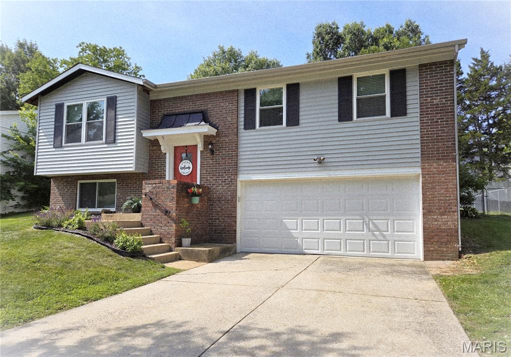 This home features 4 bedrooms & 2 full bathrooms with an oversized 2 car garage.  Other features are fresh paint throughout as well as beautiful hardwood flooring, a spacious dining room and kitchen island coffee bar having extra storage, a Newly Installed mounted microwave, lazy susan cabinet, as well as a kitchen pantry.   Just off the dining room is the backyard entrance is  the Fully Fenced Back Yard.  The lower level has a BONUS ROOM/ 4th bedroom that can also be turned into a second living room,  game room, office space or guest room.  ** New Siding/Shutters 2017, New Windows Throughout 2017, Kitchen Cabinets and Granite Island new in 2017, L/L Ceramic Shower New in 2017, New 6 Panel Doors and Trim 2026, New Main Level Bath dual sink vanity 2024.  Come see this Adorable Fenton home located in desired Rockwood School District.