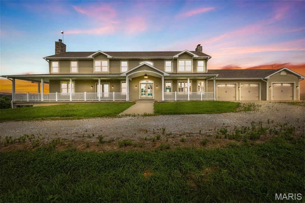 Exquisite Family Estate on 98.32 Ac +/- with Private 15 acre stocked Lake, Guest Home, Multiple Outbuildings & endless possibilities! This stately 4 bedroom 5 full bath 1.5-story home showcases superior craftsmanship along with high-end finishes throughout making it truly one of a kind. A long sweeping driveway & breathtaking views of the property & homes wraparound porch greet you on arrival. Inside, the open floorplan, gleaming hardwood floors, Designer kitchen & sunlit 2-story great rm are all competing for your attention. The kitchen has always been the heart of a home & this is no exception. Enjoy family gatherings in your designer kitchen w/ granite counters, spacious island, SS appliances, & expansive walk-in pantry plus Butler’s pantry. This Fall gather in your great room & cozy up around the wood burning fireplace that showcases floor to ceiling stone & a wall of windows with remote-operated blinds on upper windows. The main-level owner’s suite offers a wood burning fireplace, spa-like en-suite w/ custom Onyx shower, dual vanities, & dual walk-ins. Upstairs includes 3 spacious bedrooms, 2 baths, loft area, & laundry. Walkout basement features a summer kitchen, full bath, commercial freezer & cooler, laundry, &  two storm shelter/vault rooms. Geothermal HVAC, 3-car garage, 2 detached garages/shops, & 42x30 pole barn. Guest home is a 3BR/2BA modular on fdn. Endless potential, family estate, corporate retreat, equestrian haven, or hunting lodge! Too many extras to list!