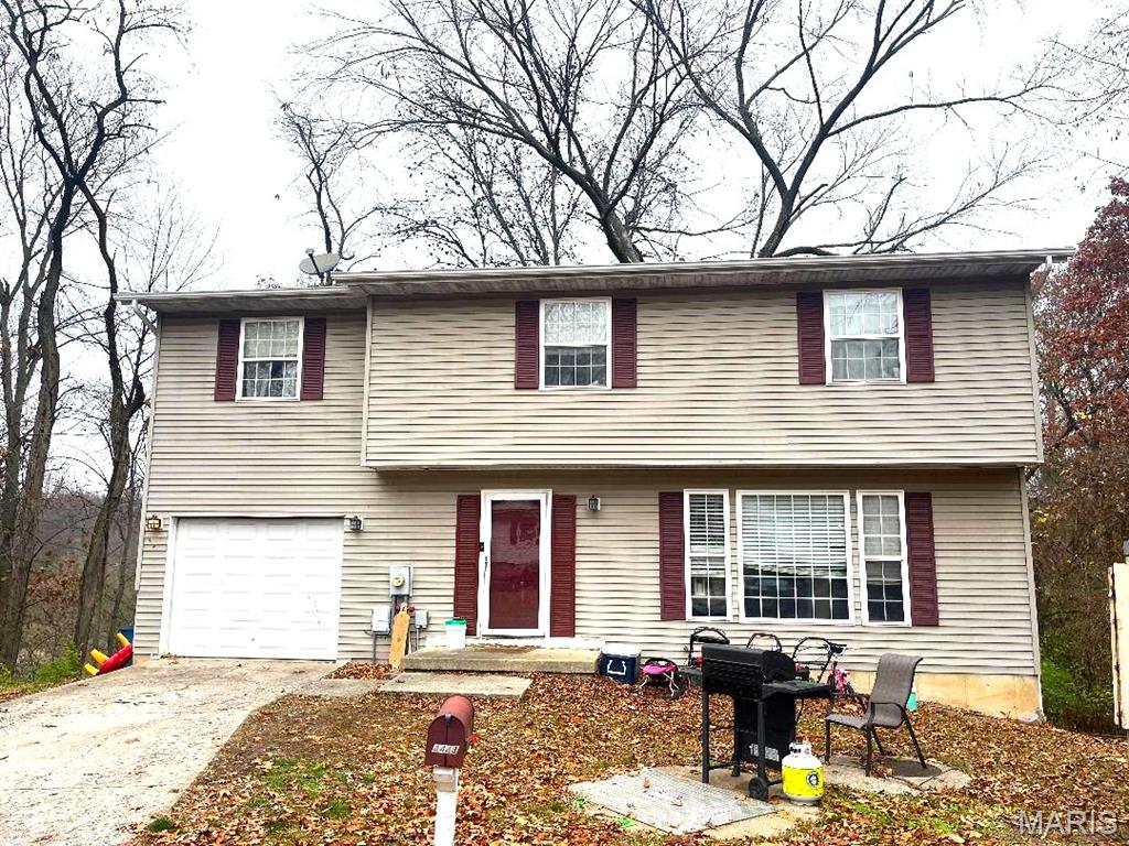This spacious 2-story home features 4 bedrooms, 3 baths, main floor laundry, luxury vinyl flooring throughout.  There is also a full walk-out basement that is partially finished, a deck off the dining area, a covered patio and an attached garage.  Home has a wooded back yard and is situated on a cul-de-sac lot.  Home being sold AS-IS.
