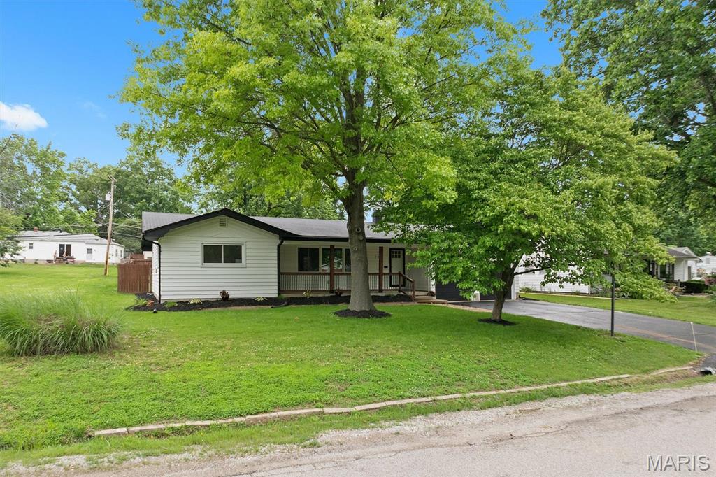 Welcome to this 3BR/2.5BA modern farmhouse filled with contemporary upgrades and an easy, move-in-ready feel—an ideal match for first-time buyers. Refreshed landscaping leads to a large covered front porch and a bright, spacious living room. All three bedrooms and a full bath connect directly to the main living area for simple, everyday convenience. A separate dining room opens to the upgraded kitchen featuring stainless steel appliances & granite countertops, with a half bath nearby for added functionality. The lower level offers outstanding flexibility with a family room, three additional rooms for storage, office use, or hobby space, plus a full bath and a laundry room with a large utility sink. The level, fenced backyard includes a 21x11 composite deck with pergola, perfect for outdoor relaxation or entertaining. An additional storage shed and a generous 2-car garage add even more value. Major updates include a younger roof & HVAC system, a brand-new water heater, windows & a fully refreshed interior for peace of mind. A stylish, updated home with the space and upgrades you definitely want to see. Conveniently located near shopping, dining, parks, schools, public transportation, and just minutes from Scott AFB and St. Louis.
