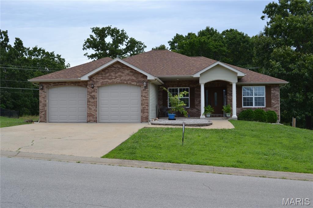 Welcome to this 4 bedroom, 3 bath home located in the Woodridge Subdivision. Step through the front door into an open living room with a gas fireplace, formal dining area or sitting room, an eat-in kitchen with a breakfast bar & nook, stainless steel appliances, and a pantry.  Main level features a primary suite with a jetted tub, separate shower, double vanity, and walk-in closet and 2 other bedrooms, full bath and laundry room. Head down to the fully finished walkout basement that features a massive family room, a recreation room with a bar, barstools, and a mini fridge, a pool table and accessories that stays.  Another bedroom, full bath, a place for an office, and a storm/storage room. Don't forget about the deck that has built in seating.  All this and about 10 minutes to everything!!