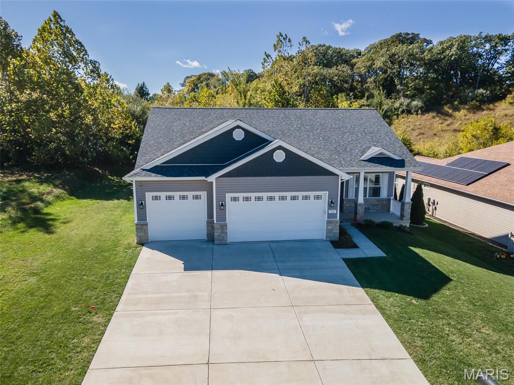 Why wait to build when you can move right into this like-new 2023 ranch in the desirable Tanglewood community? With over 3,000 square feet of finished living space, this beautifully maintained home offers the perfect blend of modern style, thoughtful design, and everyday functionality.

The open-concept main level features luxury vinyl plank flooring, cathedral ceilings, a split-bedroom floor plan, and a spacious kitchen with tall cabinetry, a large solid surface island, and a breakfast area that flows seamlessly into the living room—ideal for entertaining or everyday living.

The finished lower level nearly doubles your living space with 9-foot ceilings, a large family room, a fourth bedroom, and a full bath, creating the perfect setup for guests, multi-generational living, a home office, or recreation space.

The oversized three-car garage is complete with an epoxy-coated floor and an electric vehicle charger, while the home's newer construction means you can enjoy modern finishes without the wait, uncertainty, or added expense of building.

Located in the Collinsville School District, Tanglewood offers stocked fishing lakes, walking trails, a playground, and a gazebo, providing a neighborhood you'll enjoy as much as the home itself.

Move-in ready and meticulously maintained—this is one you won't want to miss. Ask about available financing incentives with an acceptable offer.