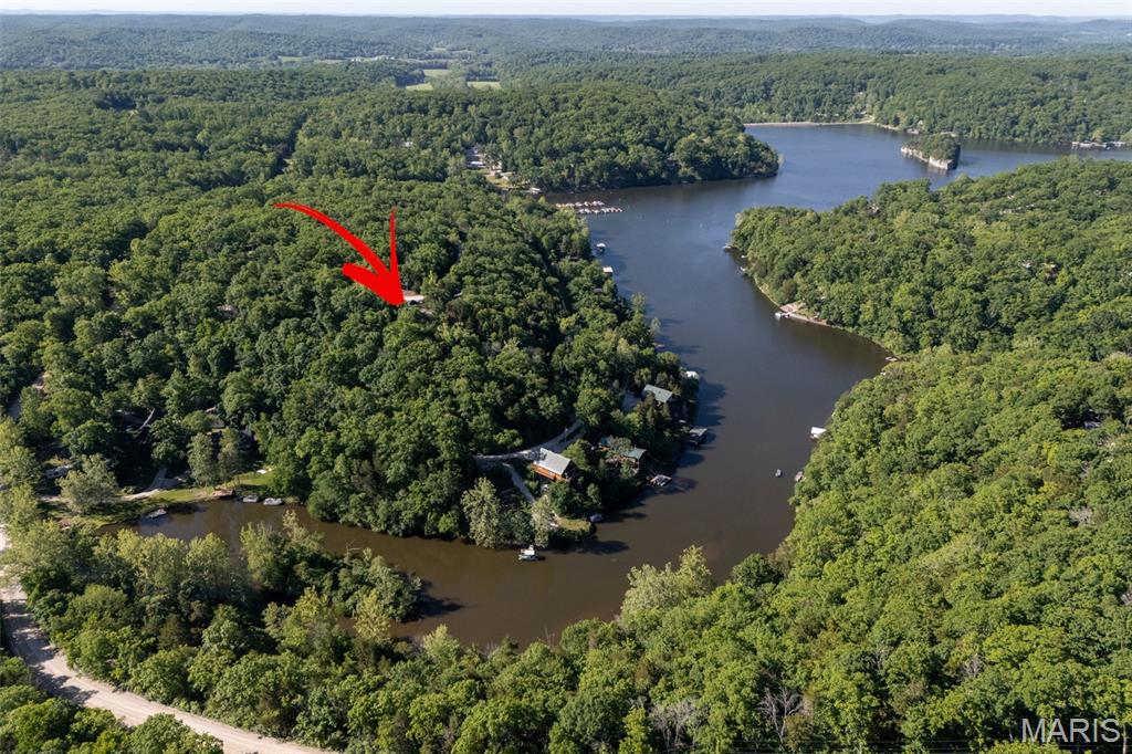 Your completely turnkey weekend getaway awaits, just in time for summer! Conveniently located a short drive from the main gate, this feature-packed recreational lot at Lake Pinnacle has it all. The wooded, 1/3 acre property includes a 2006 Rockwood Travel Trailer, protected by a 35' x 18' x 12' carport with enclosed sides. Enjoy relaxing evenings around the large firepit area—complete with Adirondack chairs—and utilize the 10' x 8' shed for extra storage. Electricity and a 1,000-gallon holding tank with a high-water alarm are already installed for your convenience. Lake Pinnacle is a private gated community boasting a 130-acre, spring-fed lake perfect for year-round fishing, boating (50 HP max), and swimming. Community amenities include a sandy beach, pavilion, playground, pickleball courts, and boat docks. Note: Campers are permitted for recreational use only and may not be used as a permanent dwelling.