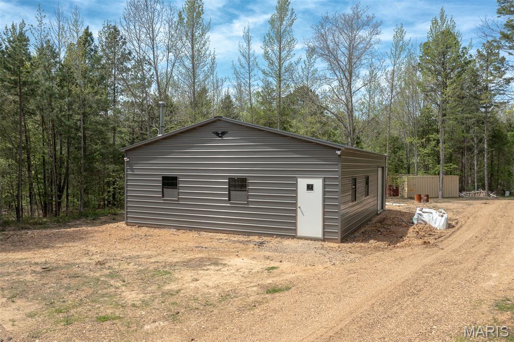 Does a remote spot, next to a creek, with a Newly Constructed 30' x 40' Building that is an open canvas, complete with Electric, Water, and Septic sound inviting?  If so, this is the listing for you!!  Just minutes from downtown Marquand, down County Road 310, and tucked away on the West side of County Road 311, you'll find this haven with endless possibilities awaiting YOUR vision!  The owner is leaving behind lots of building materials to help you complete the interior to your specifications, plus two metal shipping containers (each 8' x 20') that serve as additional storage for all the things you will want to enjoy the recreational possibilities afforded at this country retreat!  The recently surveyed 3.22 Acre lot has the perfect combination of natural habitat, fresh water, and beautiful scenery to make this the perfect home site, or recreational retreat you've been looking for.