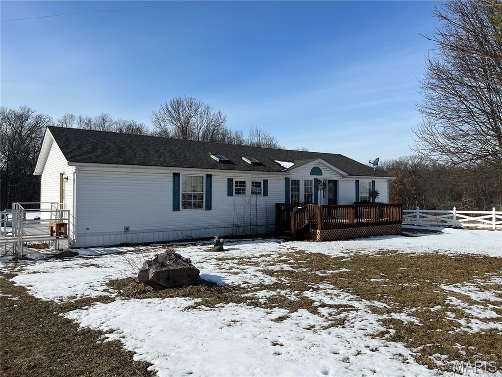 Manufactured home and outbuilding on nearly 6 acres. No known restrictions. Property has some fencing