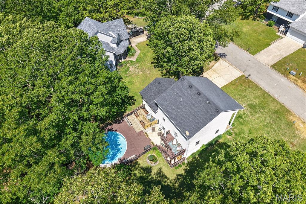 Welcome to the kind of home that gives everyone their own space AND still feels warm, inviting, and made for real life. Tucked away on a quiet cul-de-sac in West Waynesville and sitting on a beautiful .79-acre lot, this spacious 2-story home with a walk-out basement  has all the room you’ve been looking for — inside and out.
The large covered front porch welcomes you in, while the bright entryway with sidelights brings in tons of natural light. Inside, you’ll find multiple living spaces including TWO family/living rooms on the main level, a formal dining room and a spacious country kitchen featuring white cabinetry, solid surface countertops, pantry , breakfast nook, and with stainless steal appliances.  Upstairs offers 3 oversized bedrooms and 2 full bathrooms, including a spacious primary suite complete with a walk-in closet. Head downstairs to the basement you will  find even more living space with a cozy family room/rec room, tiled area perfect for movie nights or game days, large laundry room, full bathroom, and a non-conforming 4th bedroom perfect for guests, hobbies, office space, or whatever life throws at you.
But honestly… the backyard is where this home really starts showing off .
Step out onto the large tiered deck overlooking a peaceful, tree-lined backyard designed for relaxing and entertaining. Whether you’re floating in the above-ground pool, enjoying coffee by the koi pond, soaking up the sunshine, or planning your dream garden in the built-in raised garden space — this property gives you that “I never want to leave home” feeling. There’s even a shed for extra storage and an oversized 2-car garage with additional storage access.
This home has character, space, functionality, and a setting that’s hard to find these days. Truly a one-of-a-kind family home with room to live, relax, entertain,  make memories for years to come. Whether you’ve got a big family, love entertaining, or just want room to spread out without sitting on top of each other… this one delivers.