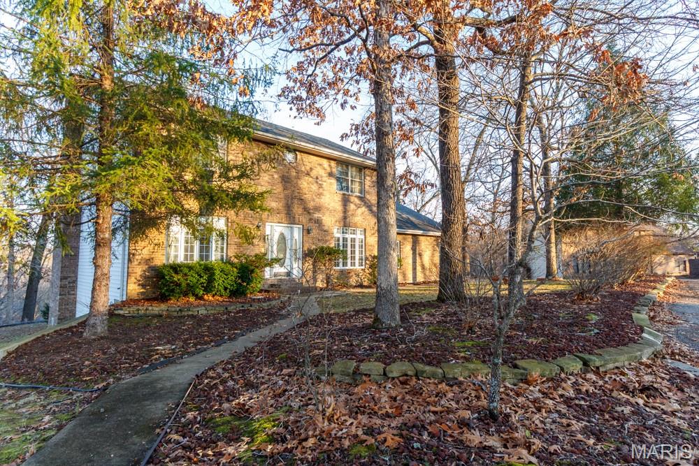 Ideal family home located on a quiet cul-de-sac in a fantastic neighborhood-located less then 10 minutes from Fort Leonard Wood. 4 Large bedrooms and 3 1/2 baths makes this roomy home perfect for any family. The Primary bedroom is on the second floor with 2 walk-in closets and double vanity en suite with beautiful light filtering in from each end of the house... lovely French doors on main level between parlor and living room provide easy expansion for family/social gatherings or closing off for separate cozy multi-use spaces. Special features include a unique double -sided glass door custom kitchen cabinet as well as a beautiful custom multi-shelf built -in hallway display cabinet. Stainless appliances in great condition round out the spacious kitchen. Finished walk out basement features a great room with a warm fireplace , extra bedroom, office space or game room and hook-ups for extra refrigerator /microwave. Ultra convenient workshop room within secure garage for the handyman or hobbyist. This home has Great Brick facade and built with quality materials that make this home stand out from others. A gardeners delight with slopes full of custom-planted lilies of the valley along with lily of the Nile, rose bushes , roses of Sharon, lilacs peonies and more.....Watch the sun rises with your morning coffee from the beautiful forest-bordered & private 2nd story outdoor deck that doubles for great family gatherings.