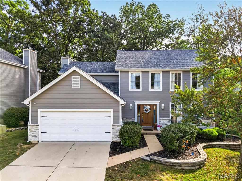 Impressive 2-story home offering 4 bedrooms, 2.5 baths, and over 1,800 sq ft of beautifully updated living space! The welcoming foyer opens to formal living and dining rooms featuring hardwood floors, crown molding, and a bright bay window. The updated kitchen boasts rich cabinetry, granite countertops, subway tile backsplash, stainless steel appliances, and an open layout to the breakfast area and great room. The great room features a wood-burning fireplace and access to a spacious 2-tier deck overlooking the private, wooded backyard. Upstairs, the vaulted primary suite offers a walk-in closet and luxurious bath with a seamless glass shower. Three additional bedrooms, including one with balcony access, and a second full bath complete the upper level. Additional highlights include a 2-car garage, walk-out lower level, custom built-ins, and numerous updates throughout. Conveniently located near Big Bend, Dougherty Ferry, shopping, dining, and major highways!