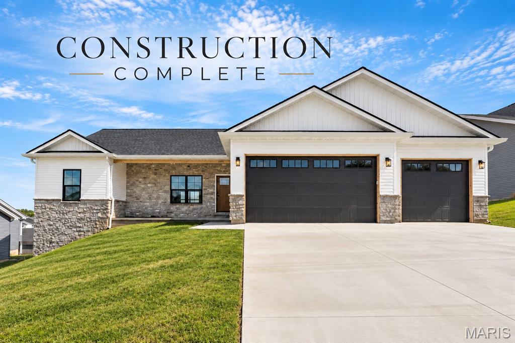 Construction Complete!!  FANTASTIC NEW PRICE!!   Some homes check boxes. This one raises the bar. Tucked inside The Overlook, one of Washington's fastest-growing communities, this 1,810-square-foot ranch IS READY FOR A NEW OWNER TO MOVE IN NOW, and it is something special. 

Step through the amazing craftsman front door set inside a covered front porch accented in full stone, and you immediately feel the difference. Vaulted ceilings soar through the great room, dining, and kitchen, pulling in light and giving every room a sense of space that photos can't fully capture. This isn't a home that just looks good. It's a home that feels good the moment you walk in.

The kitchen was designed for people who actually use their kitchen. Beautiful Quartz countertops atop White cabinetry with custom crown molding and black hardware. An oversized island with color-contrast base cabinets and a quartz top with a breakfast bar.  An oversized double composite sink in black. LVP flooring throughout. It all flows into the dining area where a full glass single door opens to the covered deck dressed with a white soffit ceiling, cedar posts/wraps and rails with black spindles, a lighted ceiling fan, and a fabulous view.

The primary suite is a genuine retreat. Walk-in shower with a glass door. Oversized double bowl vanity. A walk-in closet that actually fits your life. The secondary bedrooms are generously sized and share a well-appointed full bath. A half bath right off the garage entry handles the rest.

Three-car garage, insulated, drywalled, and finished and painted because the people who build homes like this understand that the garage matters too.

The walk-out basement is wide open with 9-foot ceilings and a full bath rough-in. The convenient design allows for flex space that can become whatever you need next. A gym. A guest suite. A rec room. The bones are there.

The exterior makes a statement before you ever reach the front door. Full stone on the front-entry covered porch, a craftsman front door, black garage doors with windows, and board-and-batten siding in the gables. The kind of curb appeal that slows people down when they drive past.

The Overlook, Washington, MO. Built by a trusted local builder who displays pride in workmanship.

This is new construction done right. Come see it today, as construction is COMPLETE!  CALL NOW!
