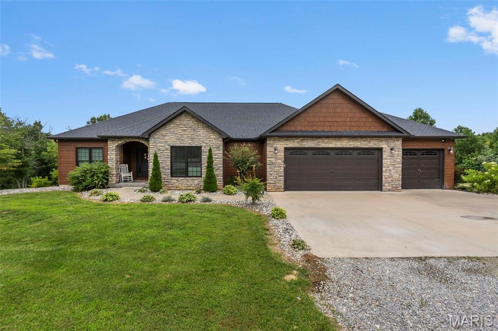 Beautifully designed and thoughtfully built, this 4 bedroom, 3 bath home offers peaceful country living on approximately 6.42 acres. Step inside to find walnut hardwood and ceramic flooring throughout the main level, a spacious kitchen with a walk-in pantry, gas range, and stunning copper farmhouse sink.

The primary suite is a true retreat, featuring a large bedroom, custom walk-in shower, soaking tub, and a generous closet with convenient access to the main-level laundry room. The finished basement offers even more space with a bedroom, bonus room, movie room, and plenty of room to spread out.

The oversized John Deere room is heated and cooled and is currently being used as a gym, giving you flexible space for hobbies, storage, equipment, or workouts. Built with efficiency in mind, this super-insulated home features high-efficiency HVAC and a tankless water heater, helping keep utility costs low.

Outside, enjoy a manicured yard, peaceful acreage, and a stocked lake perfect for year-round enjoyment. Spend your evenings relaxing on the back deck while overlooking the water and taking in the beautiful sunsets. This property truly offers the space, setting, and features so many buyers are looking for. AND NO HOA!