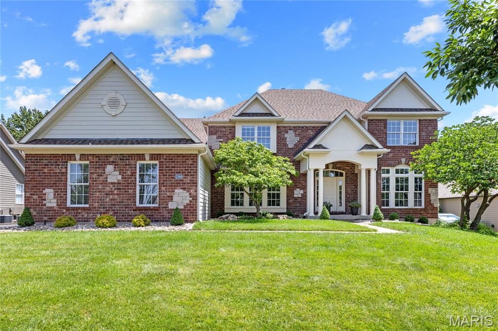 A rare opportunity to own this spectacular brick-and-stone estate in the prestigious gated community of Spring Mill Estates. Offering nearly 7,000 square feet of thoughtfully designed living space, this exceptional Fischer & Frichtel residence blends timeless elegance, superior craftsmanship, and luxurious comfort throughout. A grand foyer with a sweeping flared oak staircase creates a stunning first impression and opens to beautifully appointed living spaces, including an elegant formal dining room, sophisticated study, private home office, and an impressive great room highlighted by soaring ceilings and a dramatic wall of windows that floods the home with natural light. Designed for both everyday living and effortless entertaining, the gourmet kitchen features 42-inch white custom cabinetry, stainless steel appliances, a generous center island, and a butler's pantry. The adjoining breakfast room opens to the inviting four-season room, while the warm and welcoming hearth room showcases a floor-to-ceiling stone fireplace, creating the perfect gathering space. The upper level offers a luxurious primary suite designed as a private retreat, complete with a spa-inspired bath featuring a soaking tub, separate shower, and an adjoining bonus room ideal for a sitting room, nursery, dressing room, or private office. Three additional bedrooms provide exceptional accommodations, including one with a private ensuite bath and two connected by a Jack-and-Jill bath. The finished lower level with a 9 foot foundation is an entertainer's dream, featuring an expansive recreation room, impressive theater room, fitness studio, sleeping area and full bath. Resort-style outdoor living area complete with a built-in grilling station, expansive Trex deck, paver patio, and private sport court—offering the perfect backdrop for entertaining, recreation, and relaxing. Every detail of this extraordinary home has been thoughtfully designed to deliver an exceptional lifestyle in one of the area's most sought-after gated communities.