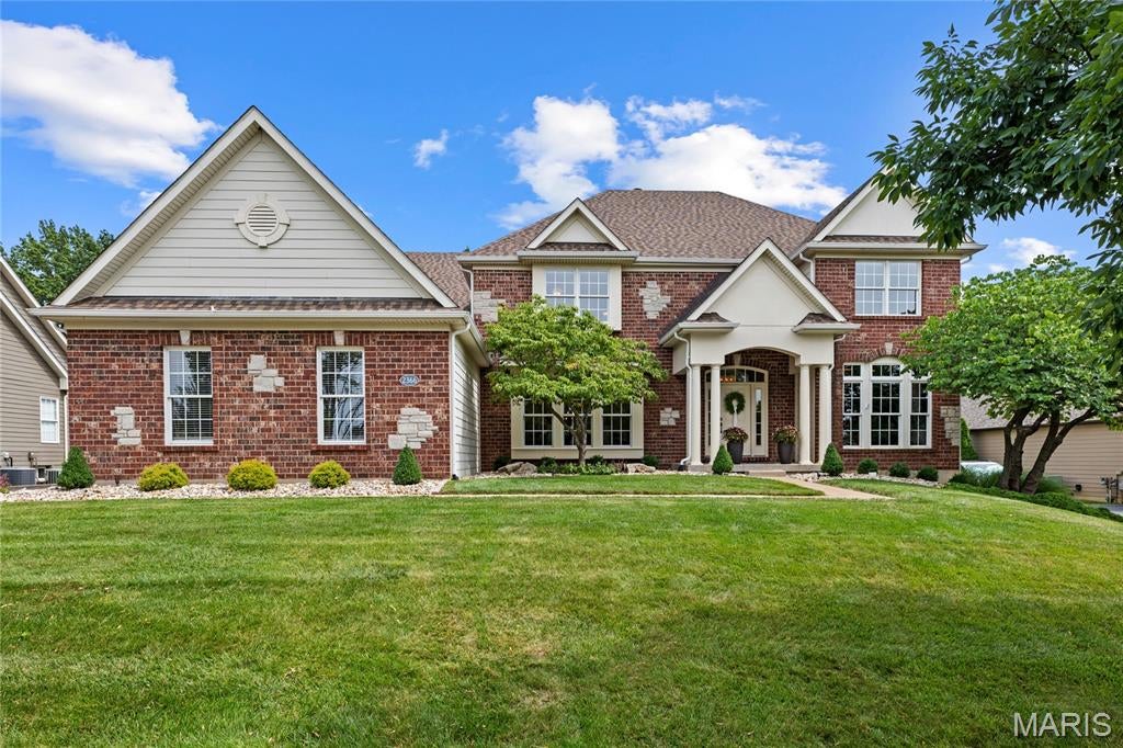 A rare opportunity to own this spectacular brick-and-stone estate in the prestigious gated community of Spring Mill Estates. Offering nearly 7,000 square feet of thoughtfully designed living space, this exceptional Fischer & Frichtel residence blends timeless elegance, superior craftsmanship, and luxurious comfort throughout. A grand foyer with a sweeping flared oak staircase creates a stunning first impression and opens to beautifully appointed living spaces, including an elegant formal dining room, sophisticated study, private home office, and an impressive great room highlighted by soaring ceilings and a dramatic wall of windows that floods the home with natural light. Designed for both everyday living and effortless entertaining, the gourmet kitchen features 42-inch white custom cabinetry, stainless steel appliances, a generous center island, and a butler's pantry. The adjoining breakfast room opens to the inviting four-season room, while the warm and welcoming hearth room showcases a floor-to-ceiling stone fireplace, creating the perfect gathering space. The upper level offers a luxurious primary suite designed as a private retreat, complete with a spa-inspired bath featuring a soaking tub, separate shower, and an adjoining bonus room ideal for a sitting room, nursery, dressing room, or private office. Three additional bedrooms provide exceptional accommodations, including one with a private ensuite bath and two connected by a Jack-and-Jill bath. The finished lower level with a 9 foot foundation is an entertainer's dream, featuring an expansive recreation room, impressive theater room, fitness studio, sleeping area and full bath. Resort-style outdoor living area complete with a built-in grilling station, expansive Trex deck, paver patio, and private sport court—offering the perfect backdrop for entertaining, recreation, and relaxing. Every detail of this extraordinary home has been thoughtfully designed to deliver an exceptional lifestyle in one of the area's most sought-after gated communities.