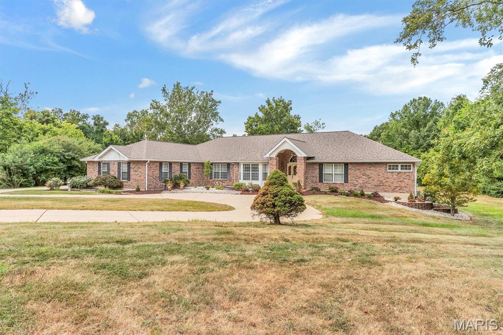 This is an INCREDIBLE Ranch style home with over 7000 sq ft!  Approximately 4500 sq ft on the main level and approximately 2700 finished in the lower level.
Main level has a grand entry into the Vaulted greatroom with stone fireplace.  A separate dining room with a coffered ceiling.  Primary suite with Luxury bath.  Open Kitchen, breakfast room, and hearth room.  Second fireplace is in the hearth room.  Three secondary bedrooms.  SIX Bathrooms:  Primary bath, hall half bath, full bath in bedroom #2,  jack n jill bath between bedroom 3 and 4, another half bath in the second hallway next to the main floor laundry and the lower level full bath.  
EXECUTIVE DEN!  The den is vaulted, lots of windows and natural light, enough space for bookcases and couches.  It looks like the OVAL OFFICE.  It includes the Bonus room/Hobby room.  
SIX GARAGES!  Main level has a 2 bay, and a separate 1 bay.  Lower Level has a tuck under 3 bay.   Circle drive in the front with another driveway to the left to large parking pad and patio. Lower level is finished with the fourth bedroom, a full bath with dual sinks,  kitchen area, LARGE open BAR area also known as the sitting room and living room.   This beautiful home overlooks the most incredible THREE ACRES!  Home has the right amount of open flat yard and surrounded by trees.   So much HOME, so much LAND, so close to highway access but yet tucked away in a quiet culdesac. Its own piece of Heaven. 
Listing Agent must approve all appointments.