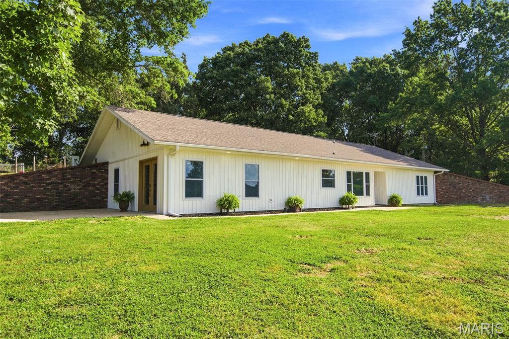 Fully remodeled home on over 4 acres, located on the edge of town at the end of a private drive for sale in the Ozarks! This move-in ready 4-bedroom (2 bedrooms are non conforming but have closets) , 3-bath home features a spacious open floor plan with LVP flooring throughout. The updated kitchen includes granite countertops, stainless appliances, and is fully equipped. Just off the kitchen is a large walk-in pantry that connects to an oversized laundry/mudroom with excellent storage space. The large primary suite offers lots of natural light, generous walk-in closet and a private bath with custom cabinetry and a walk-in shower. Energy efficiency upgrades include newer windows and a high-efficiency zoned HVAC system. Outside, the property you will find over 4 acres of usable land with room for livestock and beautiful Ozarks views(with no restrictions). Additional improvements include a 32' x 32' detached shop/garage with concrete floors, electric and heat and air & a 20' x 12' outbuilding with a 20'' x 10' lean-to. This was used for a kennel but could be made into a home office, studio, hobby space, storage or chicken coop! Rare opportunity to find a fully remodeled quality home with acreage, privacy, shop space, and move-in ready condition with great LOCATION and LOW TAXES and NO RESTRICTIONS! Call today to schedule your private showing of this exceptional property!