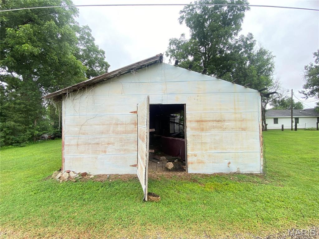 Land with metal building. Small lot located in the heart of Malden MO. Building has metal roof, entry door. Interior has large open area. Unlimited possibilities.