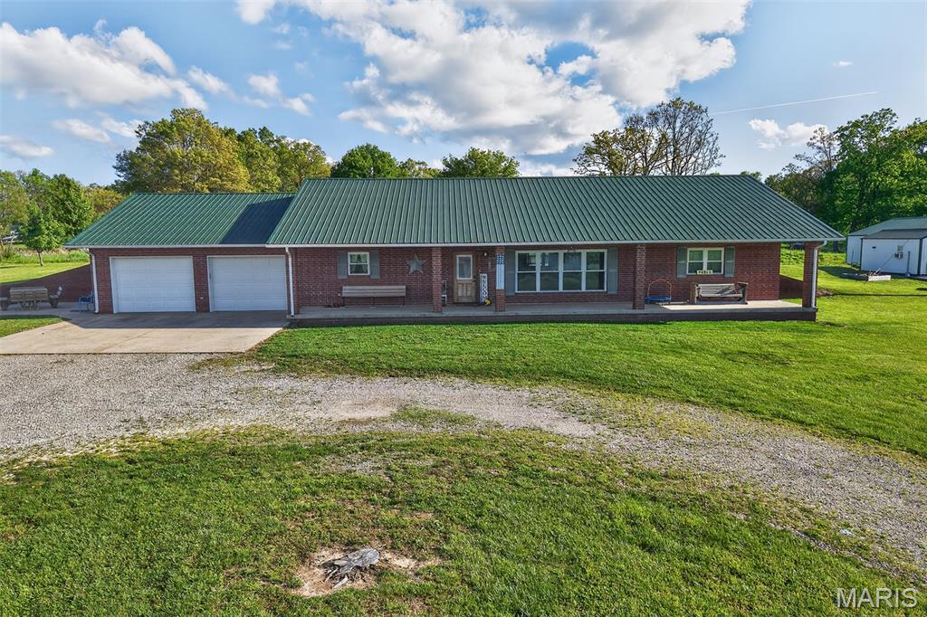 Welcome to the perfect mix of country living and convenience! This all-brick 3 bedroom, 2.5 bath home sits on 10 beautiful acres on the south side of Lebanon, offering space, and a peaceful setting just minutes from town! Inside, you’ll find a bright and open living area featuring vaulted ceiling and large windows that fill the space with natural light. The living room flows seamlessly into the kitchen and dining area, ideal for hosting family dinners and gatherings! The kitchen offers a bar area, custom cabinets and an abundance of counter space, plus a large walk-in pantry. A spacious laundry room with half bath is located just off the kitchen. Step outside and enjoy everything this property has to offer! Sip your morning coffee on the covered front porch, host get togethers on the patio, or embrace the simple life with your own clothesline and garden spot. The stocked pond, filled with catfish and bass, is perfect for relaxing afternoons! Need space for hobbies or work? The 30x60 metal shop is fully equipped with concrete floors, electric, water, and its own bathroom. There’s also a charming she shed with electric and water, perfect for a workspace, studio, or quiet retreat! All of this, surrounded by friendly neighbors and the peaceful feel of rural living without sacrificing proximity to town. This is the property you’ve been waiting for! Call today to schedule your own personal showing!